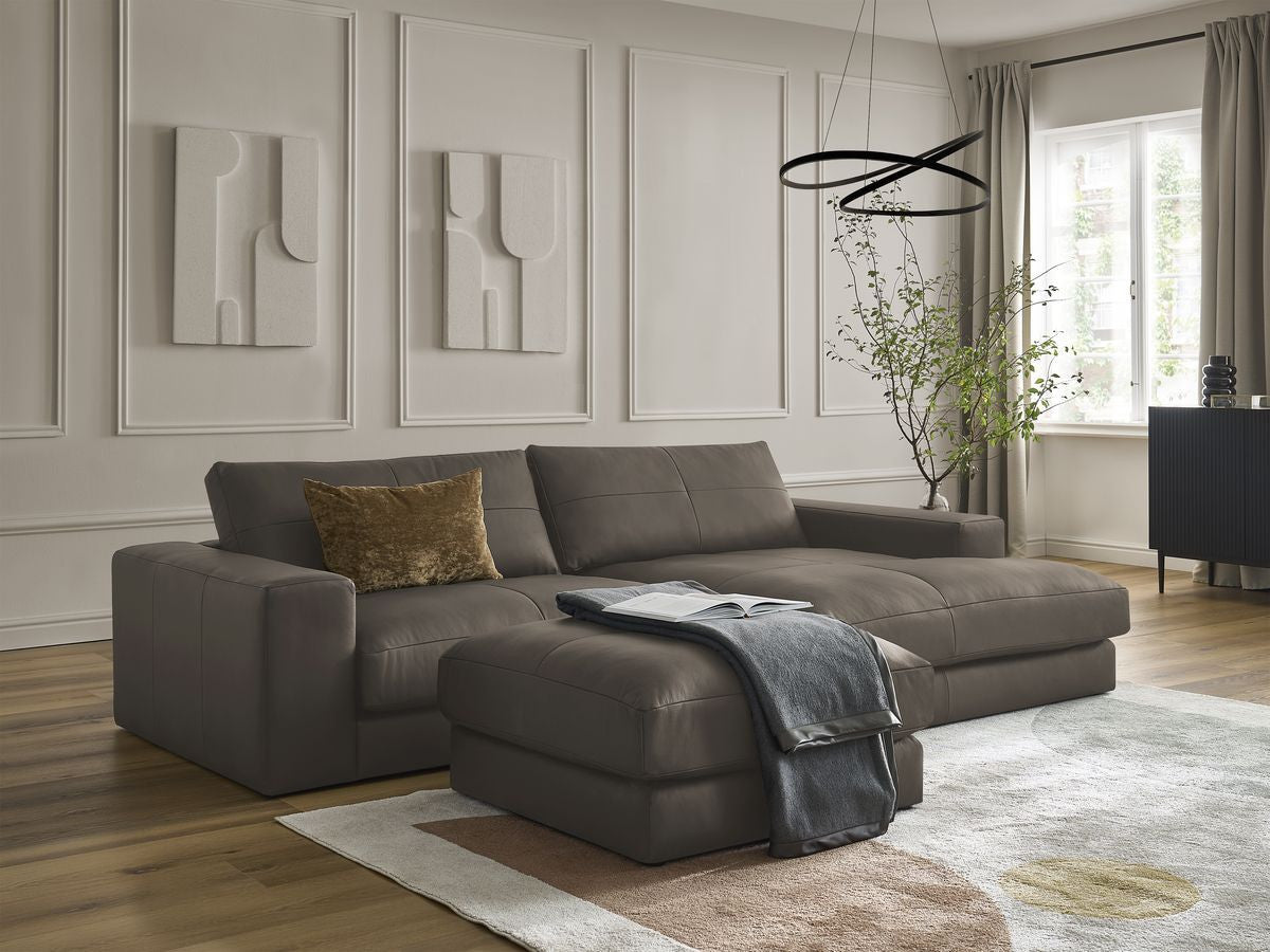 LEONARD vaste hoekbank in koeienhuid met voetenbank
