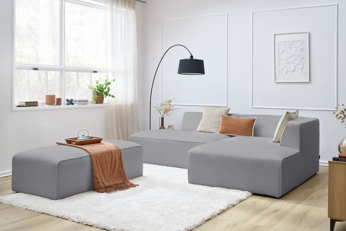 Canapé d'angle fixe modulable MEGEVE tissu bouclette avec pouf